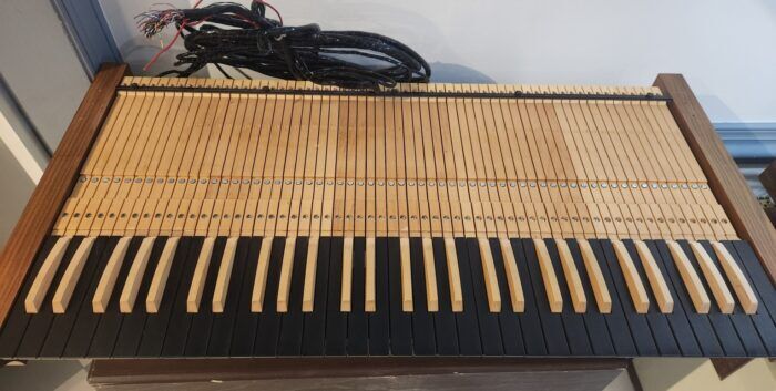 Three long throw wooden organ keyboards